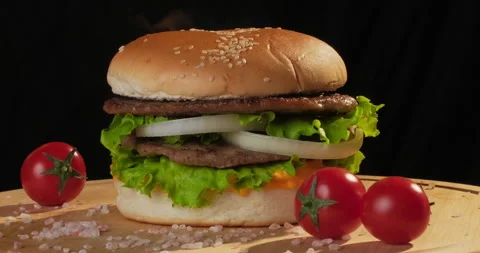 Delicious hamburger in fire isolated on black background. Party outdoors, picnic Stock Footage 296095175