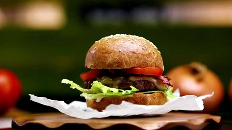 Delicious hamburger with grilled beef steak served on chef's table 4k footage Video stock 336579087