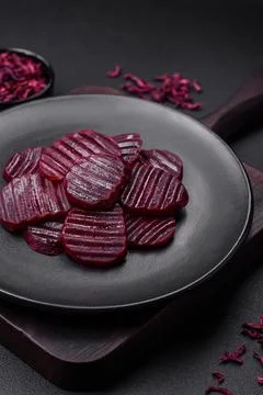Delicious healthy boiled ruby-colored beets sliced ??on a black plate Stock Photos