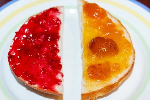 Delicious homemade breakfast with raspberry jam and apricot preserve Stock Photos