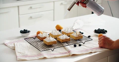 Delicious homemade desserts, on a rustic table, french meringue caramelized with Stock Footage 221084220