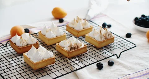 Delicious homemade desserts, on a rustic table, french meringue caramelized with Stock Footage 221084272