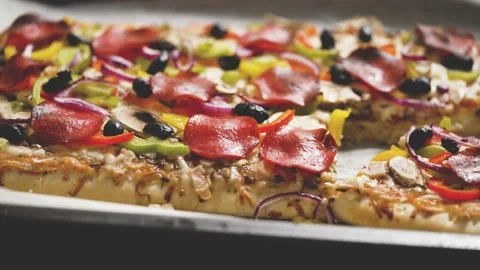 Delicious Homemade rectangular pepperoni pizza on a rustic table with Stock Footage 205452846