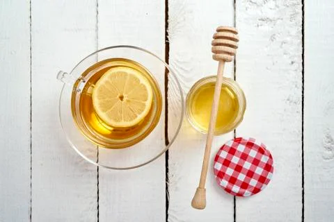 Delicious hot tea with lemon and honey on an old wooden table Stock Photos