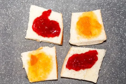 Delicious jam spread on toast bread for breakfast snack concept Фото