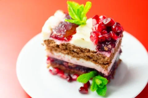 Delicious layered cake with pomegranate and mint Stock Photos