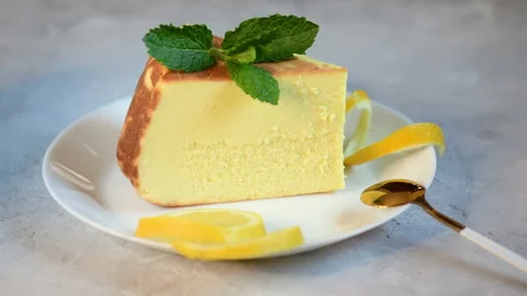 Delicious lemon cheesecake with lemon on a plate Stock Footage 153312853