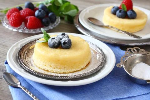 Delicious lemon pudding cake served with berries 스톡 사진