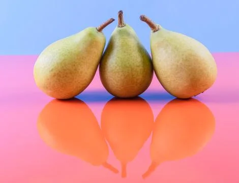 Delicious looking pears on a reflective surface Stock Photos