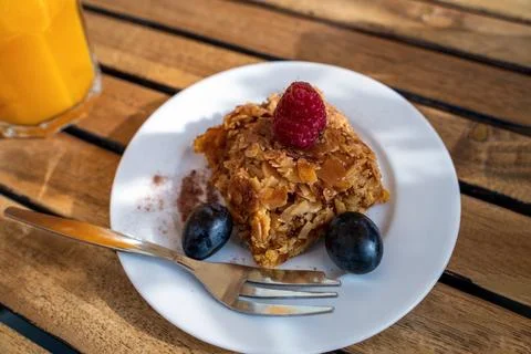 A delicious-looking slice of orange cake sits on a white plate, adorned wit.. Stock Photos
