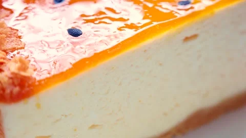 Delicious mango passionfruit cheesecake slice circle rotation close up Video stock 252426307