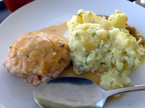 Delicious Mashed Potatoes and Cutlet Served on a Plate With Sauce at a Fami.. Stock Photos
