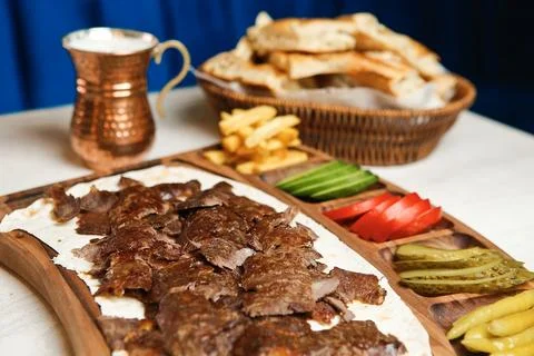 Delicious meat platter served with bread and vegetables at a restaurant Stock Photos