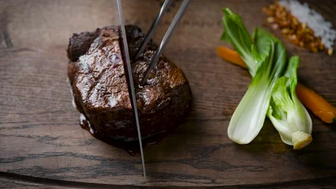 Delicious medium-rare steak. The meat is cut into pieces for eating. Stock Footage 147656820