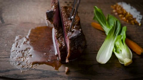 Delicious medium-rare steak. The meat is cut into pieces for eating. Stock Footage 148637472