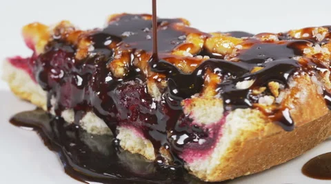 Delicious melted chocolate syrup pouring over a cherry pie Video stock 59665537