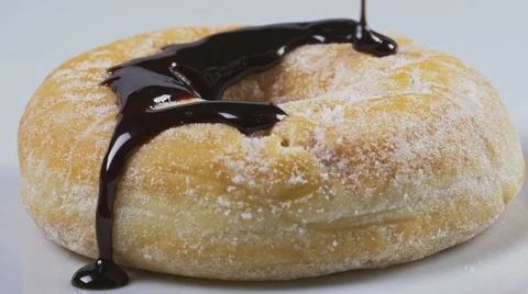 Delicious melted chocolate syrup pouring over a donut Stock Footage 59665808