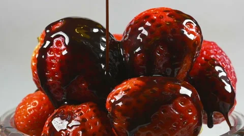 Delicious melted chocolate syrup pouring over strawberries in reverse Stock Footage 59665965