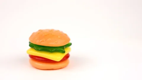 Delicious Mini Gummi Hamburger rotating on the the turn table isolated on white  Stock Footage 87217401