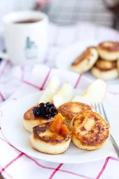 Delicious mini pancakes with fruit jam on a plate Stock Photos