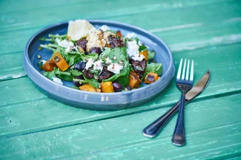 Delicious mixed salad sitting on a rustic turquoise wooden table Stock Photos