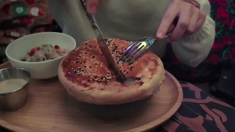 Delicious moments of breaking bread in a cozy restaurant Stock Footage 340197329