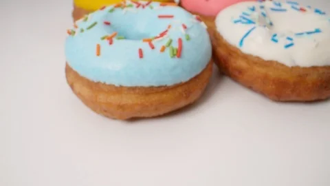 Delicious multicolored glazed donuts in a smooth motion. Stock Footage 111810951