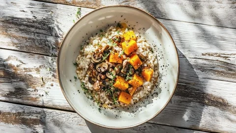 Delicious Mushroom and Pumpkin Risotto on Rustic Table Stockbeeldmateriaal 284240447