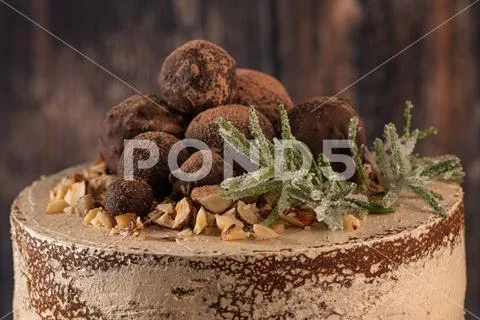 Delicious naked chocolate and hazelnuts cake on table rustic wood kitchen cou Stock Photos