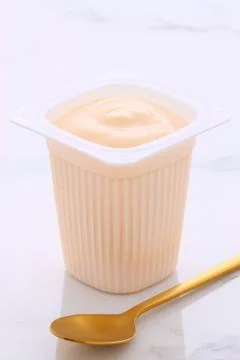 Delicious, nutritious and healthy fresh plain yogurt cup. On vintage Italian  Фото