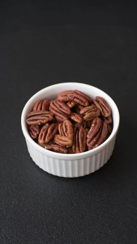Delicious nutritious pecan nuts in ceramic bowl Stock Footage 296426268