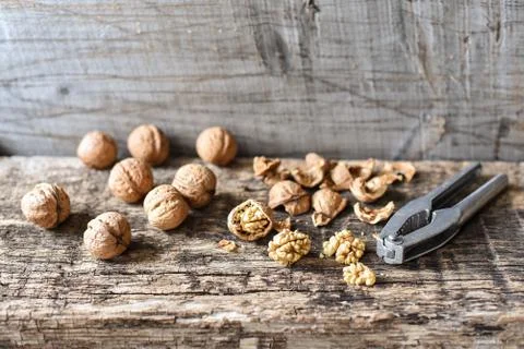 Delicious nuts and nutcrackers on an old wooden table, copyspace, set Fotos Stock