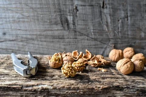 Delicious nuts and nutcrackers on an old wooden table, copyspace, set Stock Photos