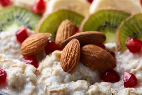 Delicious oatmeal porrige with fruits in glass bowl shallow depth of field Stock Photos