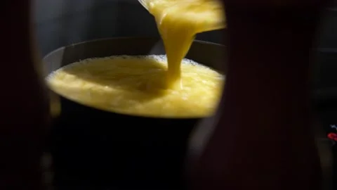 Delicious Omelette mixture being poured into a frying pan Video stock 231403235
