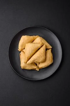 Delicious pancakes triangular shape with meat, salt and spices Stock Photos