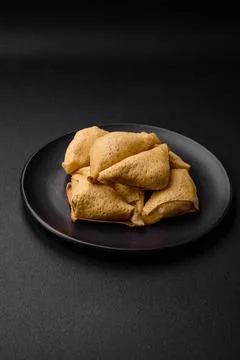 Delicious pancakes triangular shape with meat, salt and spices Stock Photos