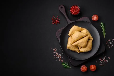 Delicious pancakes triangular shape with meat, salt and spices Stock Photos