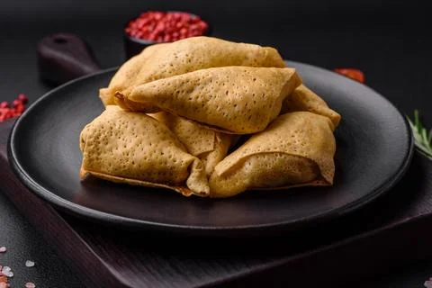 Delicious pancakes triangular shape with meat, salt and spices Stock Photos