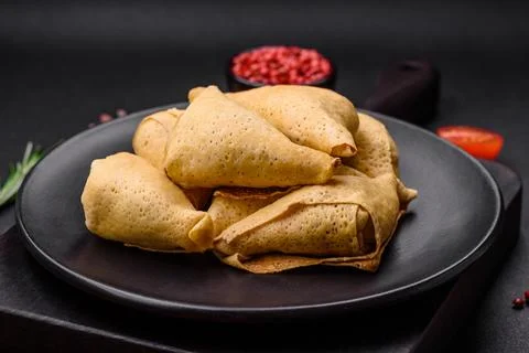 Delicious pancakes triangular shape with meat, salt and spices Stock Photos