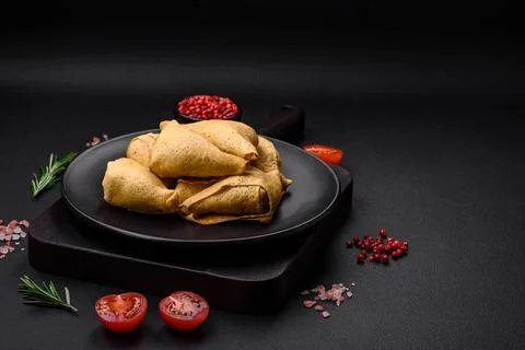 Delicious pancakes triangular shape with meat, salt and spices Stock Photos