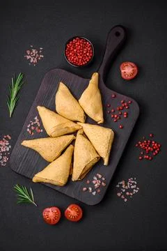 Delicious pancakes triangular shape with meat, salt and spices Stock Photos
