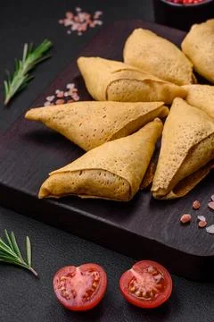 Delicious pancakes triangular shape with meat, salt and spices Stock Photos