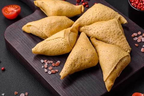 Delicious pancakes triangular shape with meat, salt and spices Stock Photos