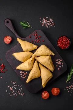 Delicious pancakes triangular shape with meat, salt and spices Stock Photos