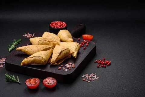 Delicious pancakes triangular shape with meat, salt and spices Delicious p... Foto stock