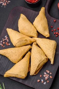 Delicious pancakes triangular shape with meat, salt and spices Delicious p... Foto stock