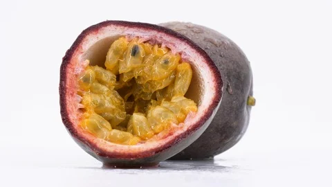 Delicious passion fruit rotating on white background, (loopable) shot in 4K. Stock-Footage 112855060