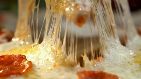 Delicious pepperoni pizza slice being lifted with gooey melted cheese strin.. Video stock 337546657