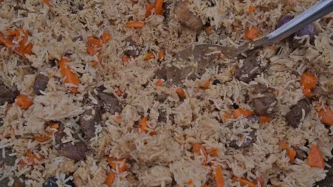 Delicious pilaf as a background with a spoon Stock Footage 131779643